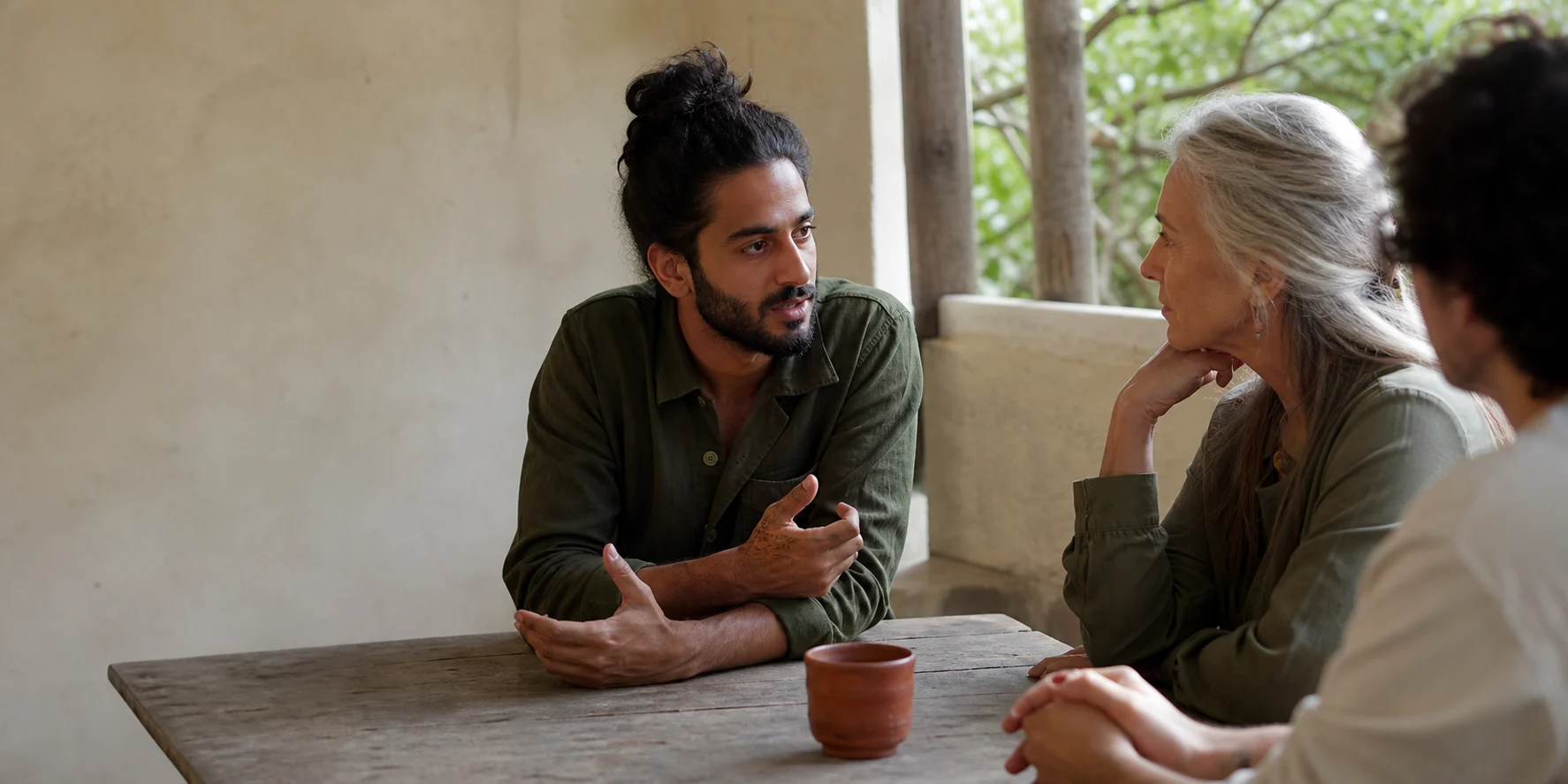 Three people giving their attention to a conversation.